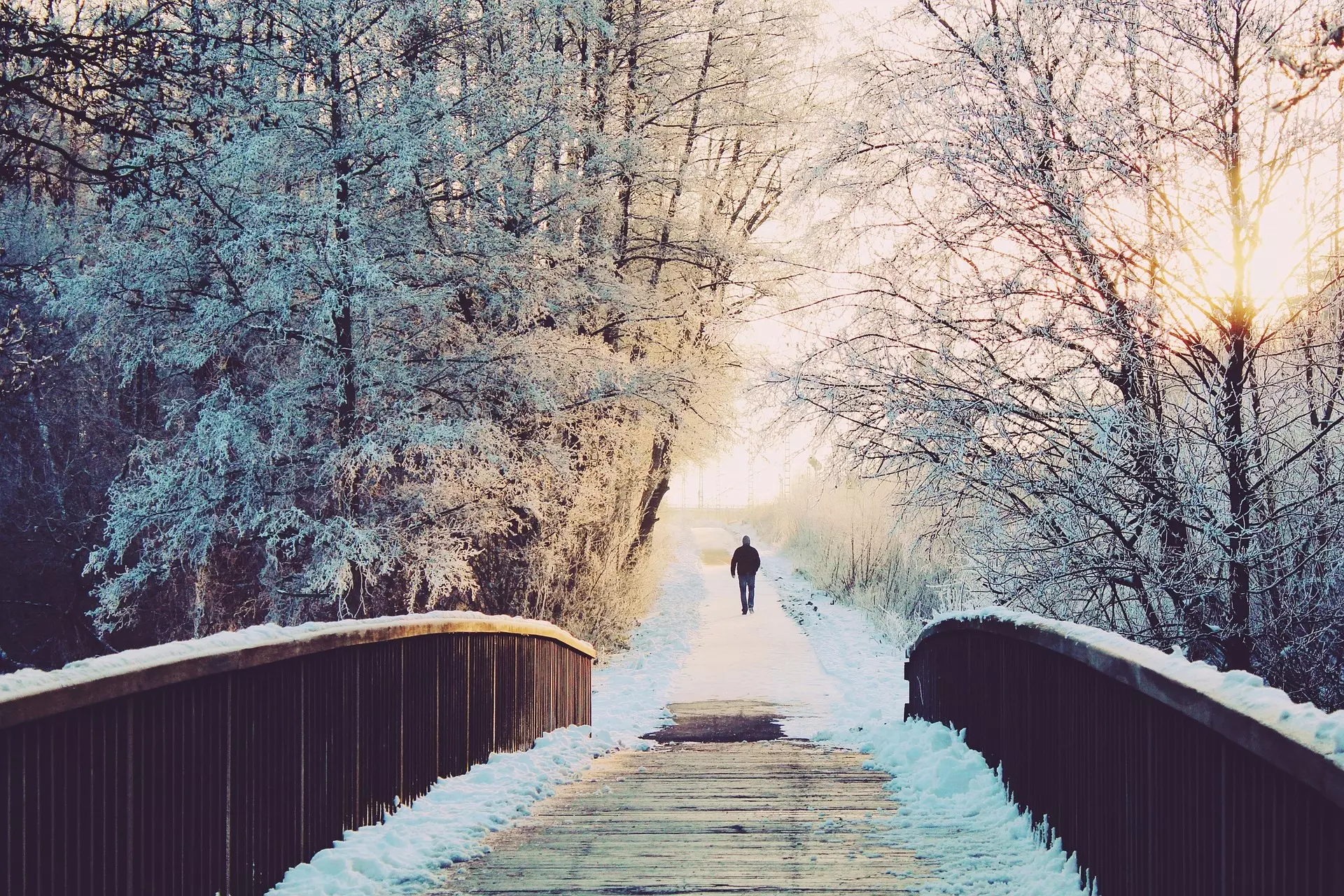 une personne marchant sur un chemin enneigé avec une passerelle - Image par Kati de https://pixabay.com/fr/photos/homme-pont-solitaire-se-promener-1156619/