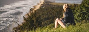 femme vue de dos, contemplant la mer depuis une montagne - Photo by Myles Tan on Unsplash