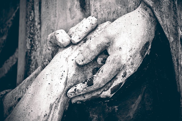 sculture de pierre dans un cimetière représentant des mains qui se tiennent - Image par Michael Gaida de Pixabay