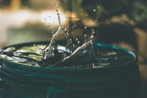 Un bocal plein d'eau jaillante - Photo de Amritanshu Sikdar sur https://unsplash.com/fr/photos/goutte-deau-sur-la-photo-du-seau-LoGnr-w1D8E