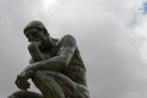 Photo de la statue du penseur au Musée Rodin à Paris, la tête dans les nuages - Photo par Jean-David & Anne-Laure - https://commons.wikimedia.org/wiki/File:Le_Penseur.jpg