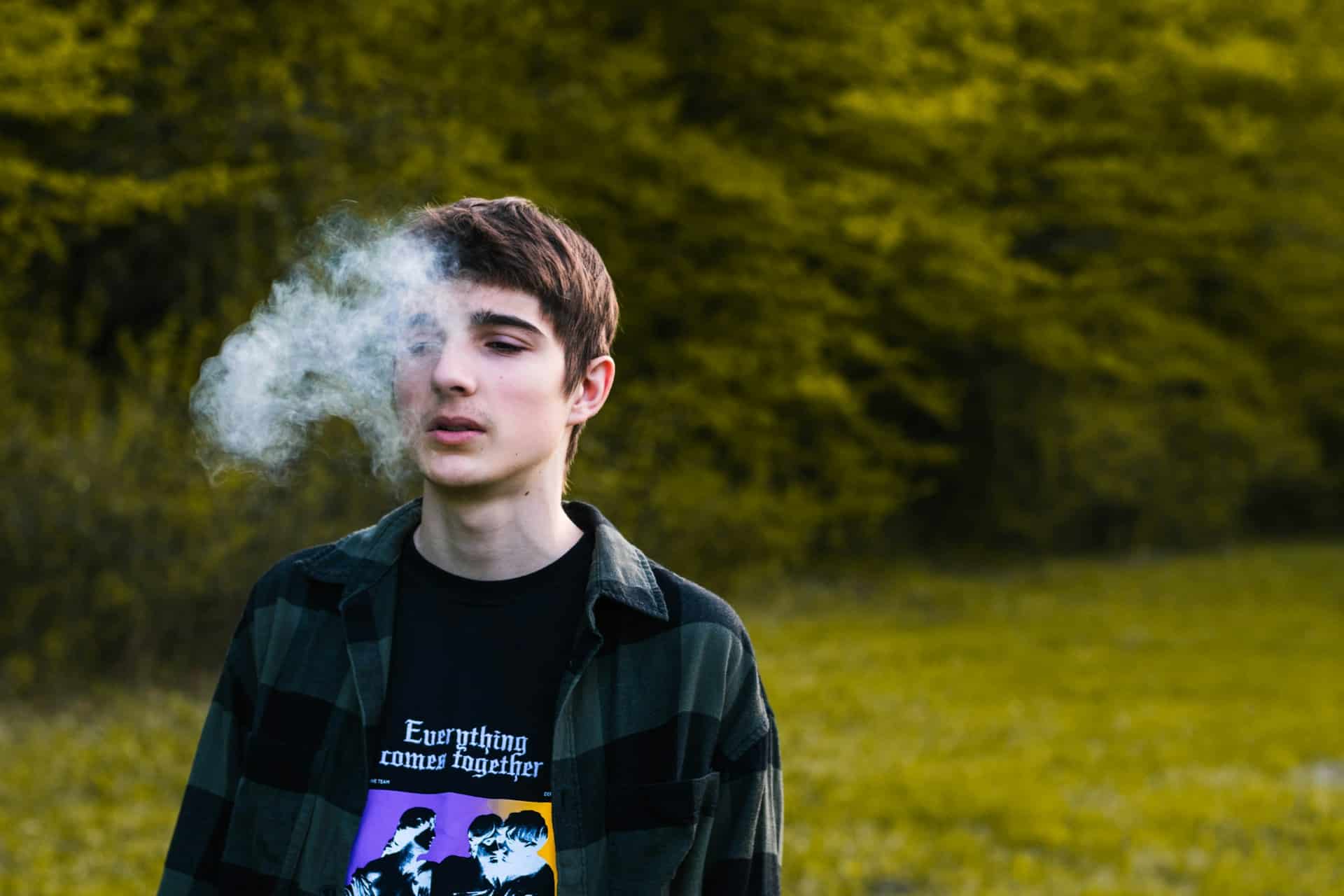 Un adolescent en train de fumer - Photo de Sebastian Radu sur https://unsplash.com/fr/photos/un-homme-avec-un-nuage-de-fumee-blanche-derriere-lui-8JXofiODAxg