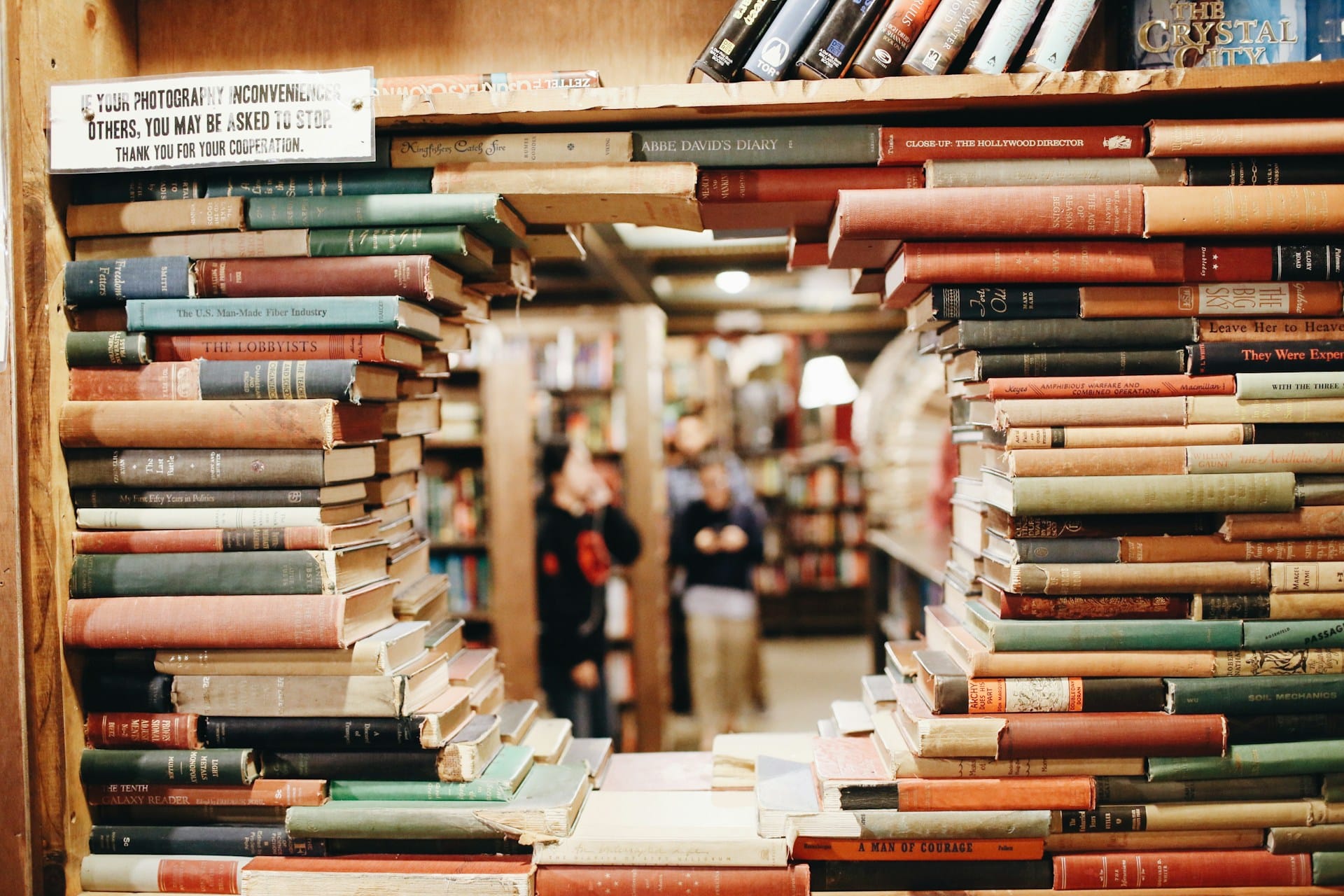 Des piles de livres forment comme une fenêtre à travers laquelle on regarde les autres et le monde - Photo de Fallon Michael sur https://unsplash.com/fr/photos/livres-sur-etagere-en-bois-marron-qmlGWIaIgpo