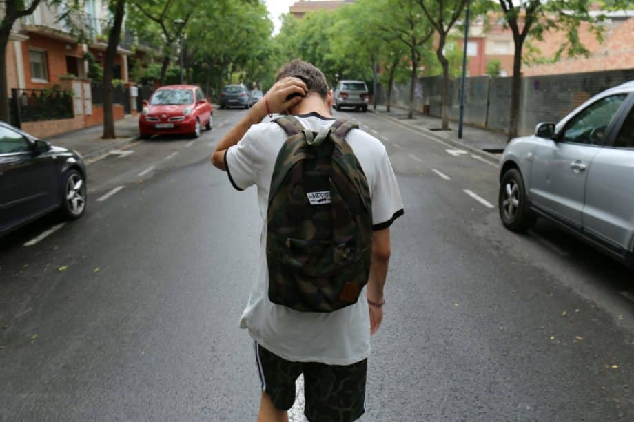 Un adolescent tourne le dos en se grattant la tête et s'en va - Photo de Jesús Rodríguez sur https://unsplash.com/fr/photos/garcon-vetu-dune-chemise-blanche-et-dun-short-noir-portant-un-sac-a-dos-debout-sur-une-route-en-beton-noir-entre-les-vehicules-et-les-arbres-pendant-la-journee-NcWNzEAD7Fs